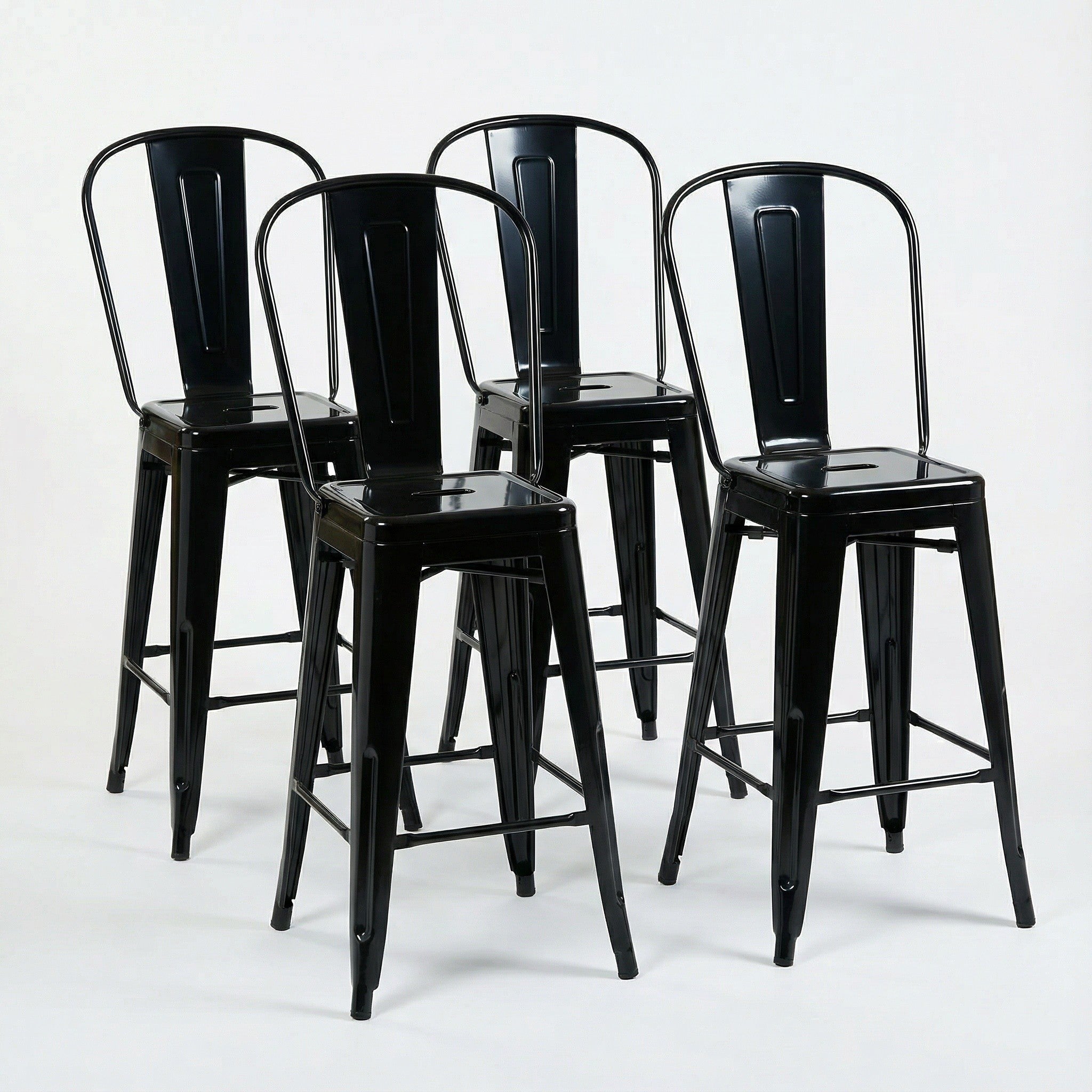 Four black metal bar stools on a white background