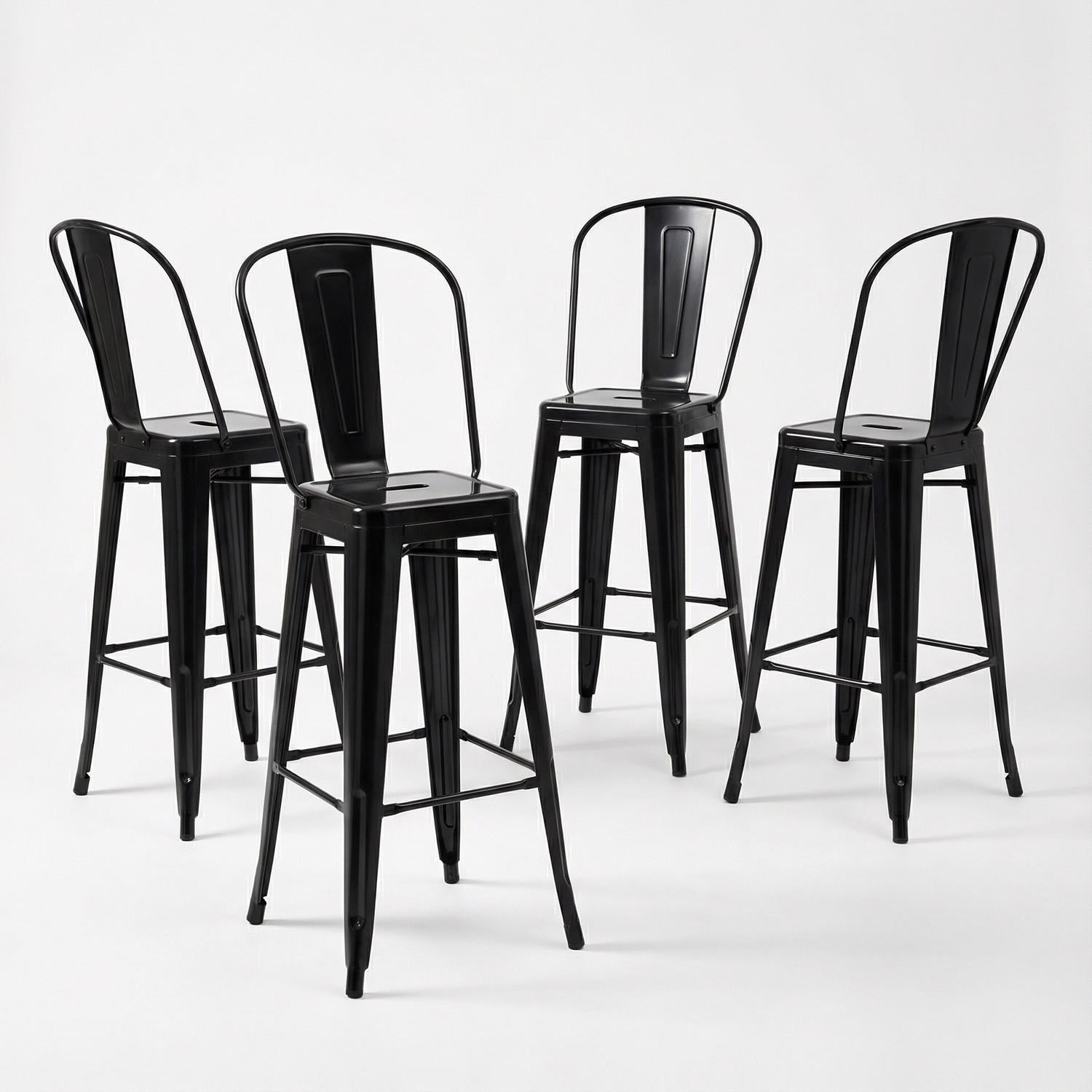 Set of four black metal bar stools on a white background