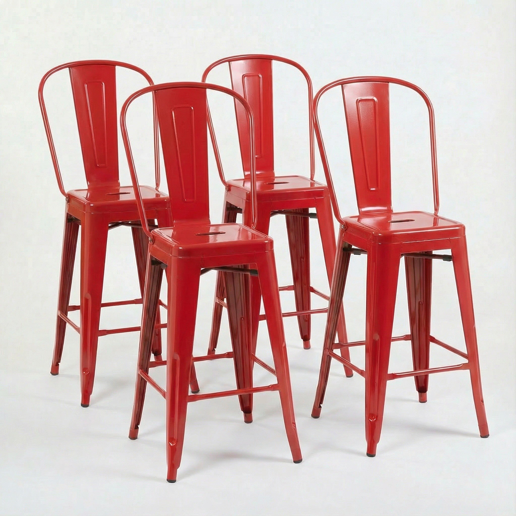 Four red metal bar stools on a white background