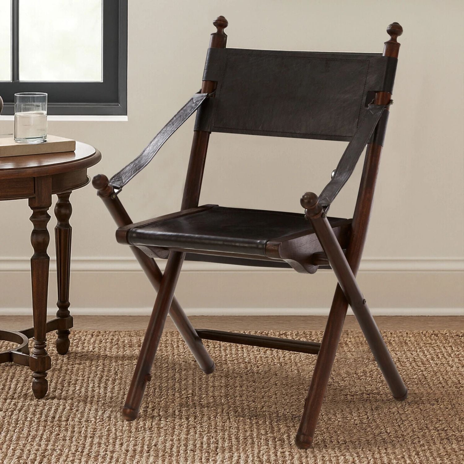 Wooden chair with black leather seat and backrest in a room setting.