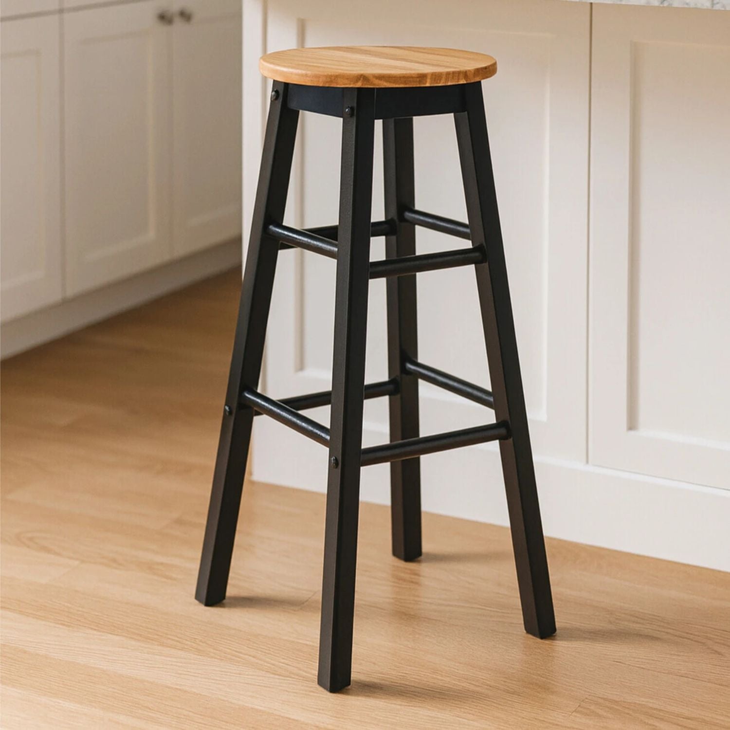 Bar stool with wooden seat on a wooden floor in a kitchen setting