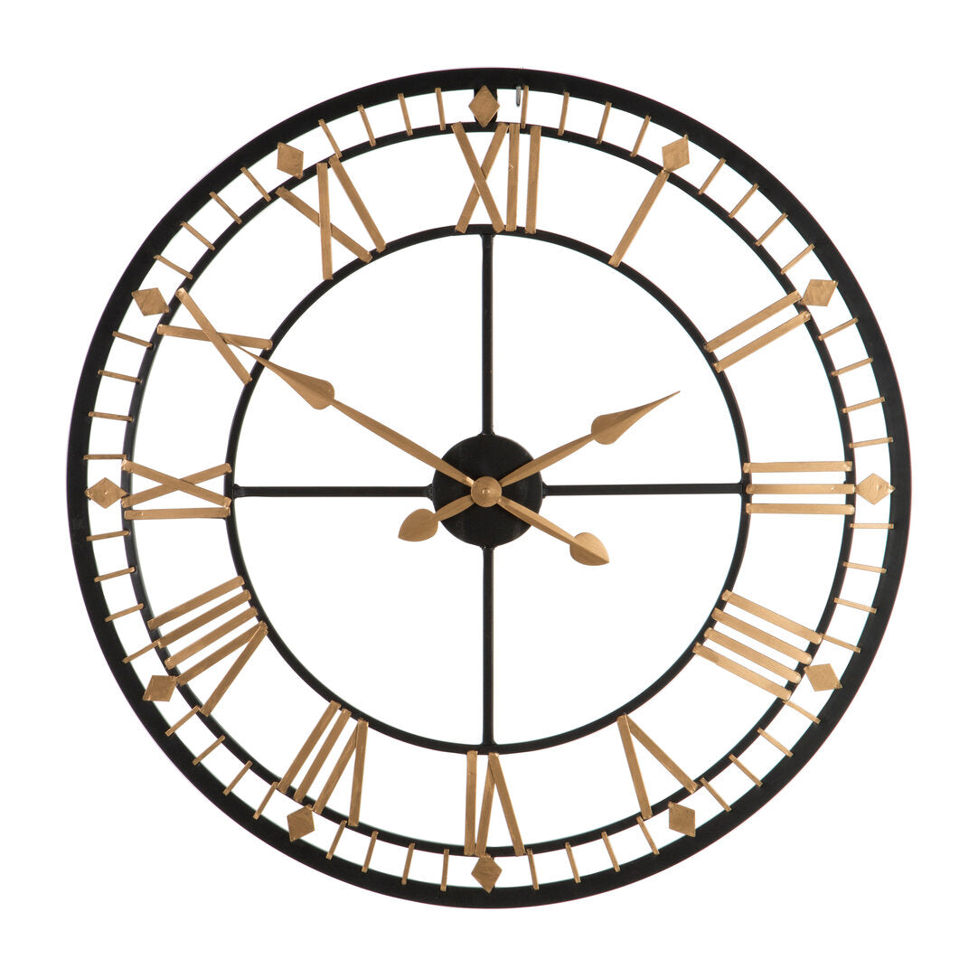Large round wall clock with gold Roman numerals on a white background