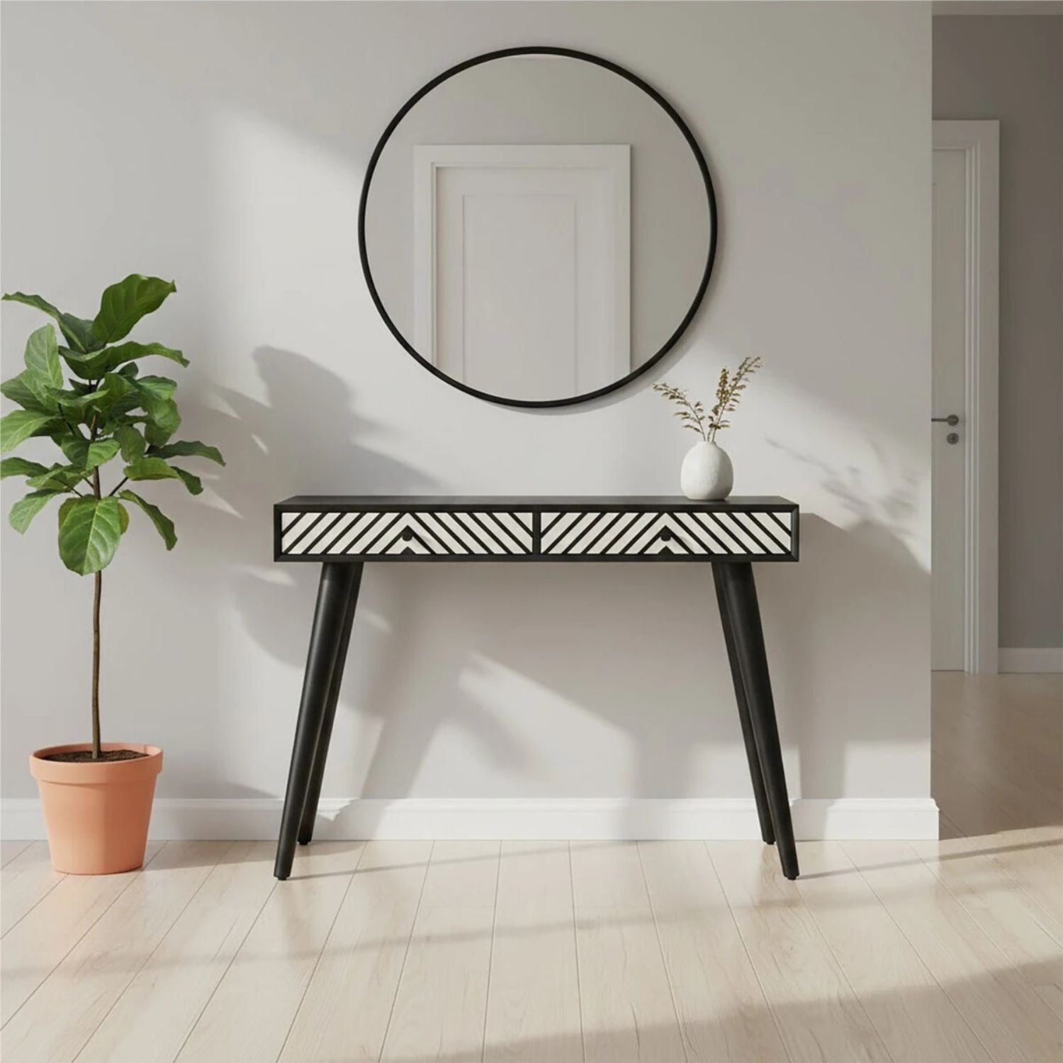 Console table with decorative mirror and plant in a minimalistic room