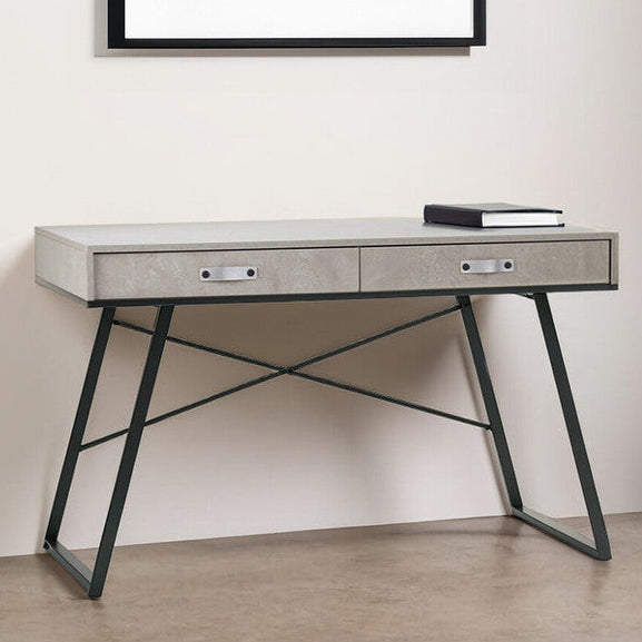 Modern desk with a framed abstract painting on the wall in a minimalistic room.