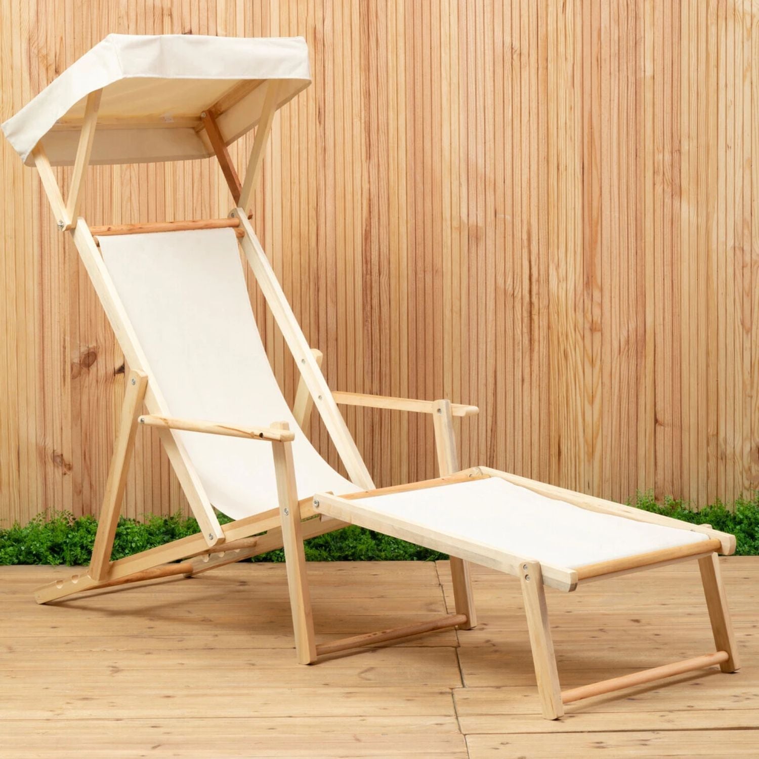 Wooden deck chair with canopy on a wooden floor against a wooden wall.