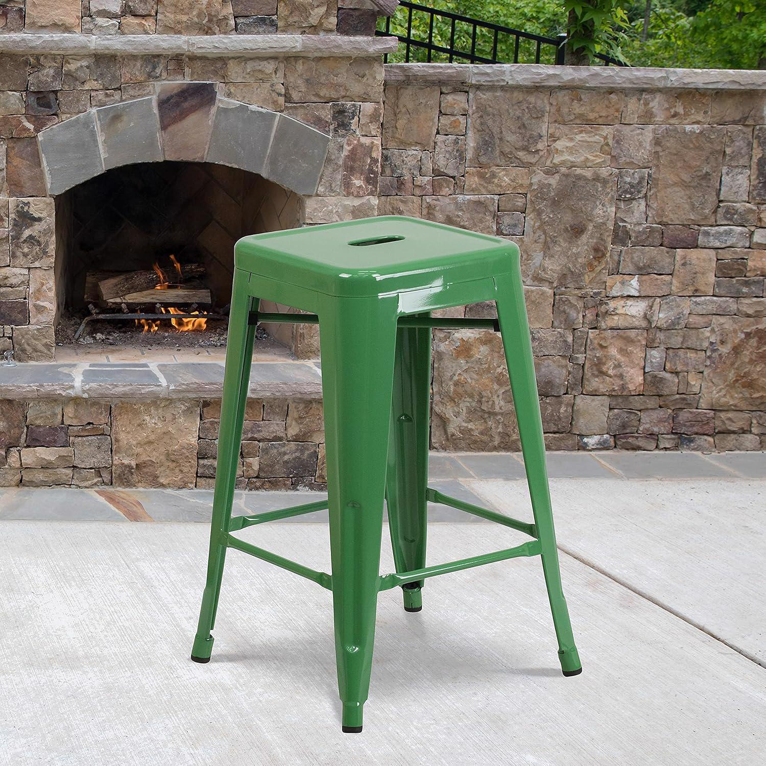 Green metal stool in front of a stone fireplace