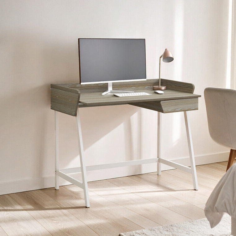 Modern desk with computer monitor in a minimalistic room