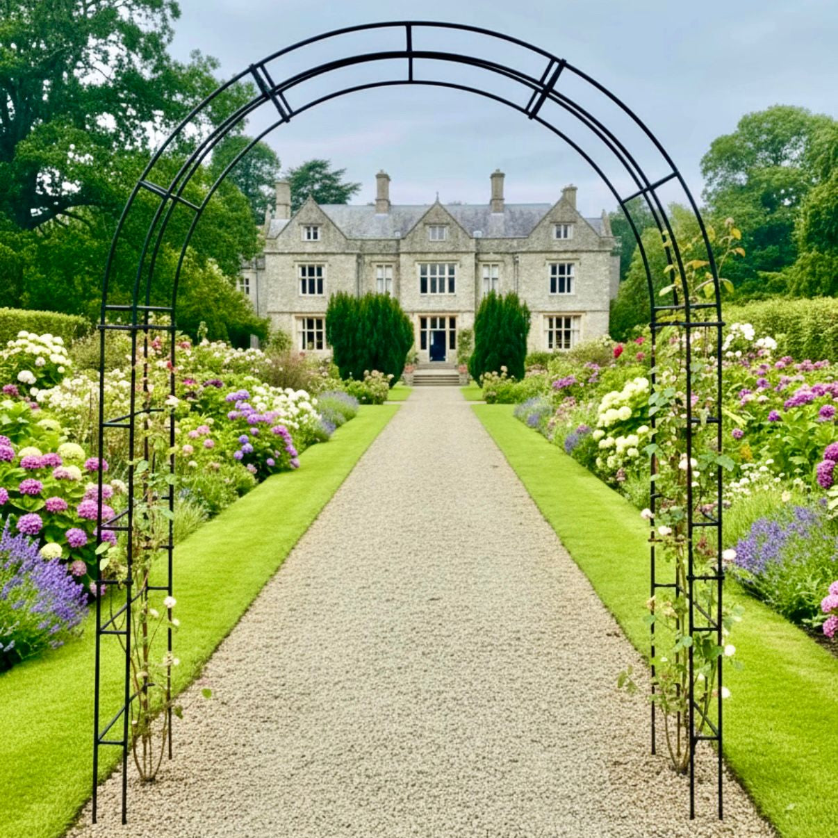 Garden pathway leading to a house with floral arches on either side