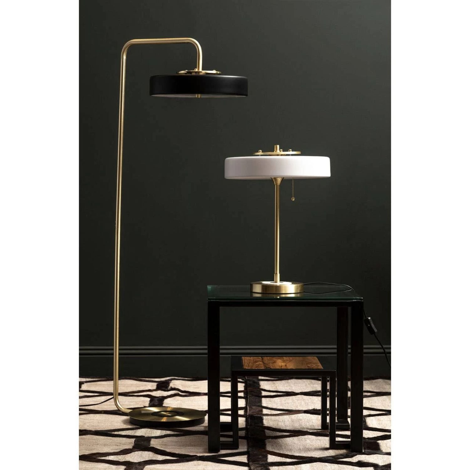 Modern floor and table lamps against a dark wall.