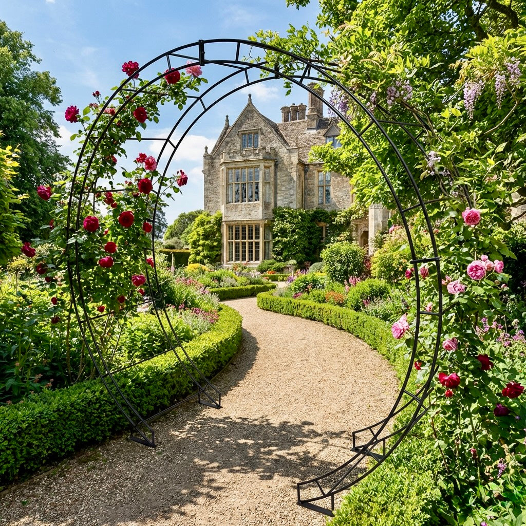 Garden archway with flowers leading to a manor house